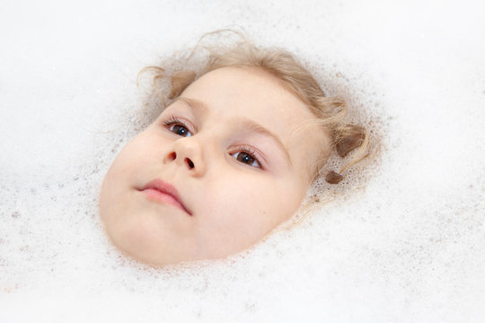 Children Caucasian face in white bath soap