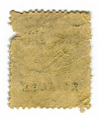The reverse side of a postage stamp.