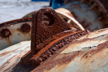 Rusted attachment welded to a large corroded steel pipe - obrazy, fototapety, plakaty
