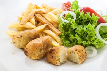 portuguese codfish cake with french fries and vegetables