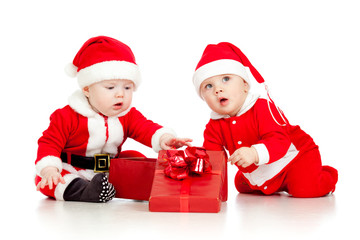 babies boys in Santa Claus clothes with gift box
