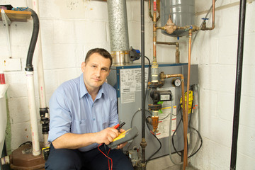 Plumber repairs furnace