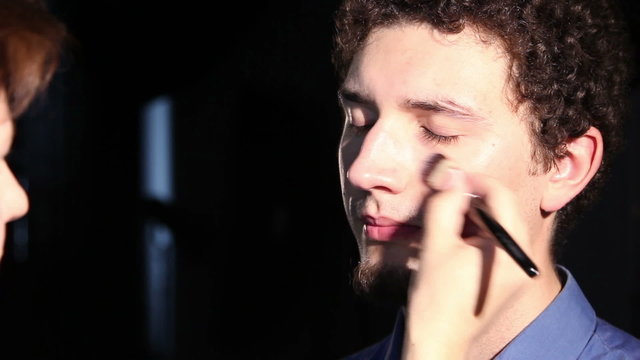 young man doing make-up
