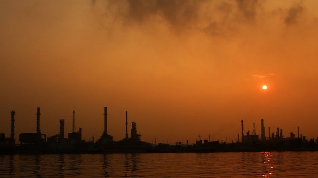 River and oil refinery factory with reflection