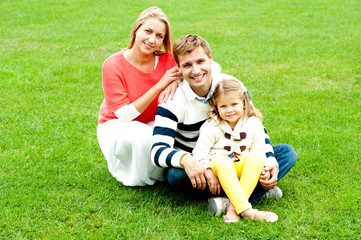 Naklejka na ściany i meble Portrait of happy young family with daughter
