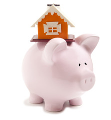Piggy bank with small model house isolated