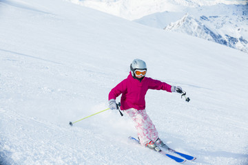 Happy little girl skiing downhill