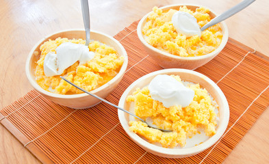 polenta corn traditional food cooking in wooden dish