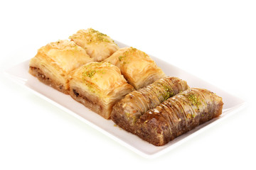 Sweet baklava on plate isolated on white