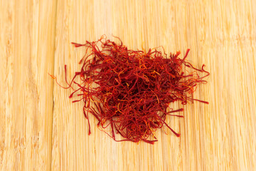 Fototapeta premium stigmas of saffron on wooden background close-up