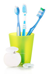 Toothbrushes, chewing gum and dental floss isolated on white
