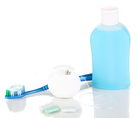 Toothbrush, chewing gum and dental floss isolated on white