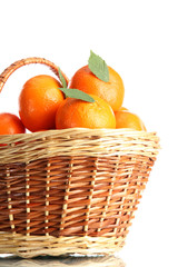 tangerines with leaves in a beautiful basket isolated on white