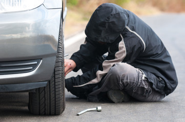 Young man repairing car outdoors