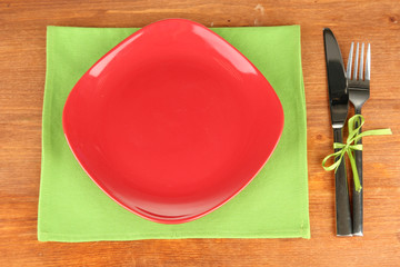 Empty square red plate with fork and knife