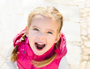 Cute little girl smiling in a park