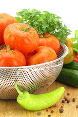 Fresh tomatoes in metal colander