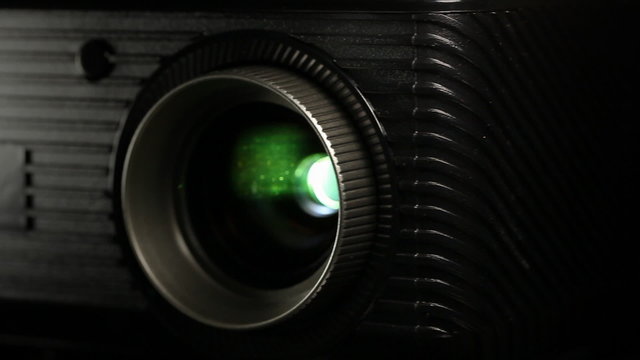 Front view of digital  film projector lens in action