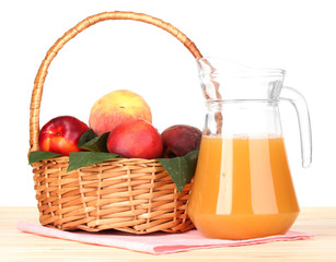 Ripe peaches in basket and juice