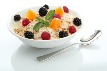 tasty oatmeal with berries, isolated on white