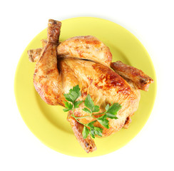 Roasted whole chicken on a green plate isolated on white