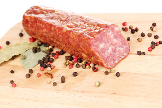 Tasty sausage on chopping board close-up