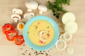 Fragrant soup in blue bowl with ingredients around