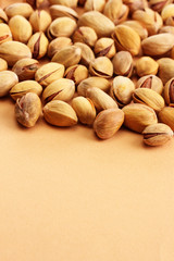 tasty pistachio nuts, on beige background