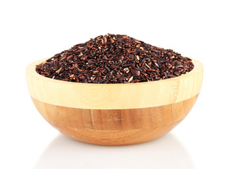black rice in a  brown wooden plat, isolated on white