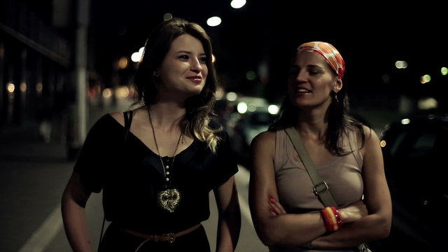 Two female friends chatting in the city, steadicam shot
