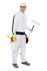 painter in white overalls holding paint brush bucket on a white