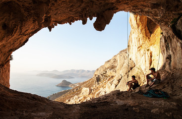 Two rock climbers having a rest. Kalymnos Island, Greece.