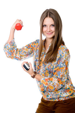 Portrait of a smiling young woman with dumbbell in one hand and