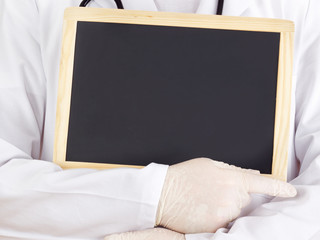 Doctor shows information on blackboard