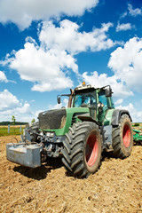 Ploughing tractor at field cultivation work
