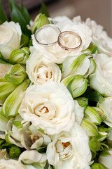 Gold wedding rings on flower