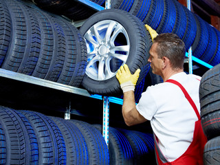 Car mechanic stores winter tires for tire changing
