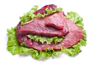 Raw meat on lettuce leaves.