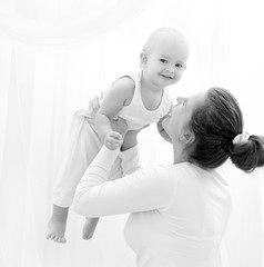 Mother and daughter play in the bedroom