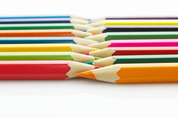 Row of colored pencils, on white background