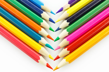 Row of colored pencils, on white background