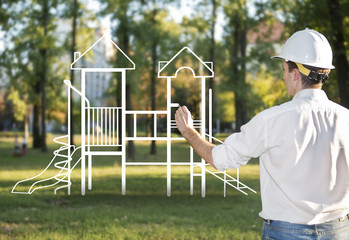 Architect drawing a playground for children in park