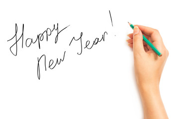 Woman's hand with a pencil writing Happy New Year