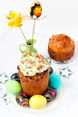 Panettone - Italian celebration bread surrounded by colored eggs