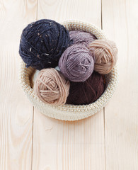 colorful balls of yarn on a wooden table