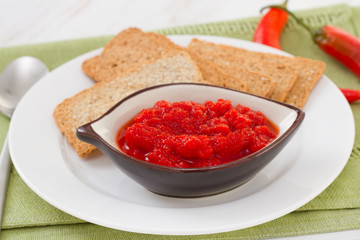sauce in small bowl with toasts on the plate