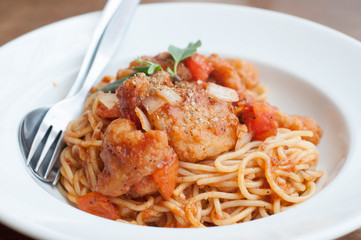 spaghetti with spicy fried fish on sauce