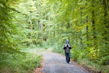 Obraz premium Little toddler boy in autumn park