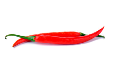 Two red chili peppers on a white