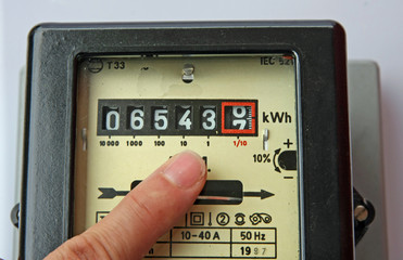 finger indicating the figures in an electric energy meter